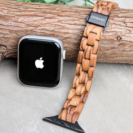 Premium walnut wooden watch strap installed on an Apple Watch showing natural grain details